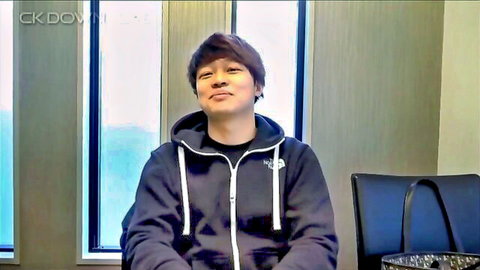 Asian man in hoodie smirking during intense JAV sex training session