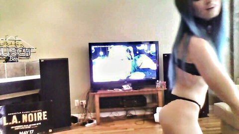 Mars Mayhem in blue hair, black thong and bandeau, sexy dance pose