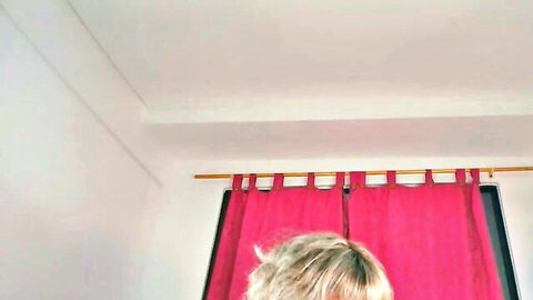 diavalo_ blonde with messy hair teasing in front of red curtains