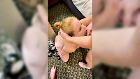 Blonde wife on knees sucking cock, man guiding her head in amateur threesome