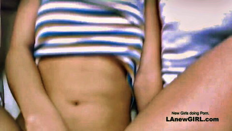 Tiny Hispanic teen in striped lingerie exposing midriff on bed