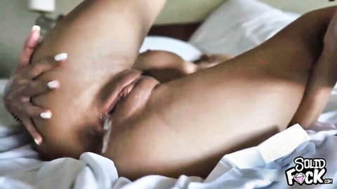 Tanned granny spreading her wet pussy on bed