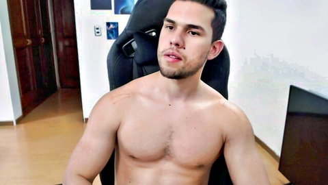 Muscular Latino guy shirtless in chair, teasing for hot gay cruising anal