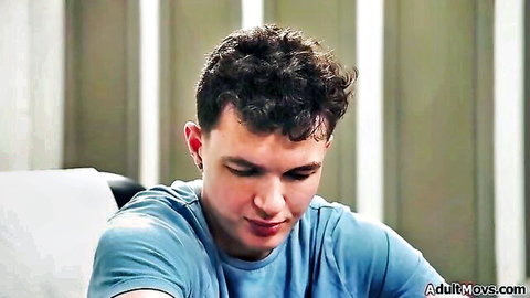 Curly-haired young man in blue t-shirt looking pensive, calling MILF doctors