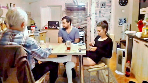 Young woman in dress and stockings lets old man fondle her in front of boyfriend