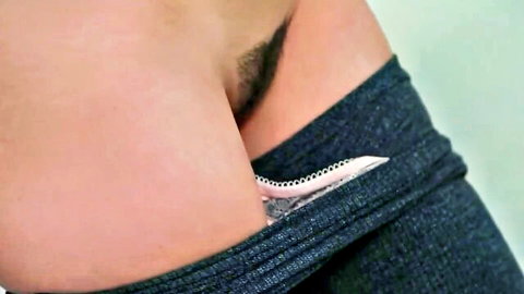Close-up of mature woman's hairy pussy with tampon insertion, jeans pulled down