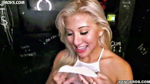 Smiling long-haired blonde with big tits holding white fabric close to her mouth in Bangbros scene