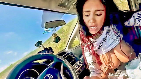 Latina woman exposes breasts while driving car POV