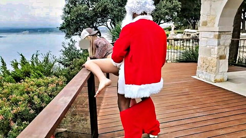 Blonde housewife bent over railing getting fucked doggy by black Santa Claus outdoors