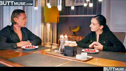 Britney Dutch in elegant black attire at dinner table with male partner