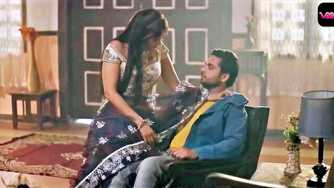 Desi woman in saree seductively touching man's face, intimate couple moment