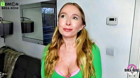 Blonde Brea Rose teases deep cleavage and big tits in tight green top