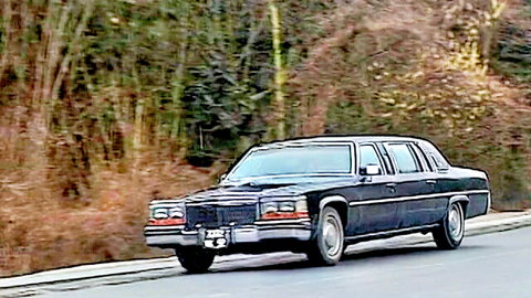 Silvia Saint's luxurious black Cadillac limo on scenic autumn road - Labyrinthe 1997