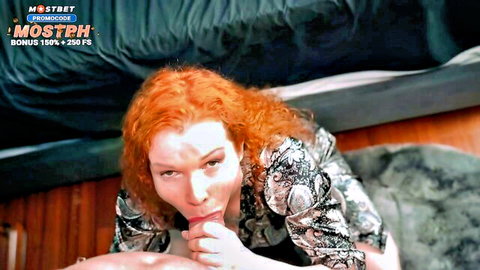 Redhead MILF with big tits puckers lips seductively teasing blowjob