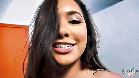 Karlee Grey smiling seductively in close-up, long dark hair and tattoo