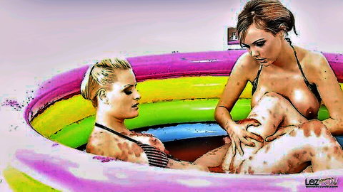 Cheerful blonde and brunette babes in bikinis finger each other in colorful pool