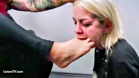 Blonde submissive woman gagged by foot in dominant BDSM scene
