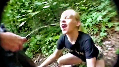 German blonde Bea S on knees in outdoor BDSM scene with rod tease