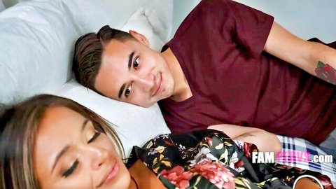 Hot Asian MILF in floral robe cuddles with Latino stepson on bed