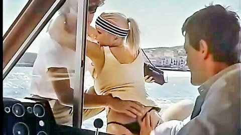Retro blonde in bikini bent over on Ibiza boat, man groping her