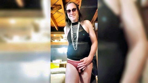Brunette trans babe with big tits posing solo in tight red panties showing cock bulge