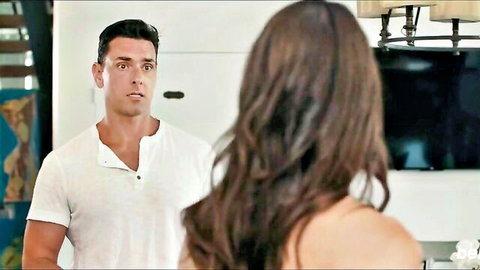 Katrina Colt in intense eye contact with muscular man in white shirt