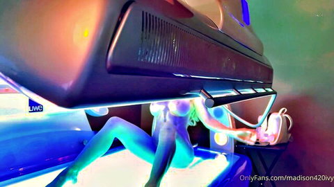 Madison Ivy nude in tanning booth, glowing under blue lights