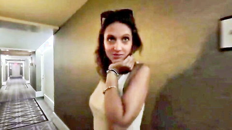 Curvy Indian brunette in off-shoulder top posing seductively in hotel hallway