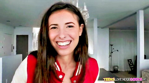 Smiling teen in red varsity jacket, long brown hair, ready for anal play - Teens Love Huge Cocks