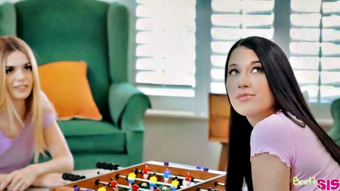 Alex Coal and blonde friend playing foosball casually