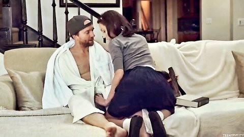 Brunette straddling muscular guy in open robe on couch, skirt hiked up exposing bare ass cheeks