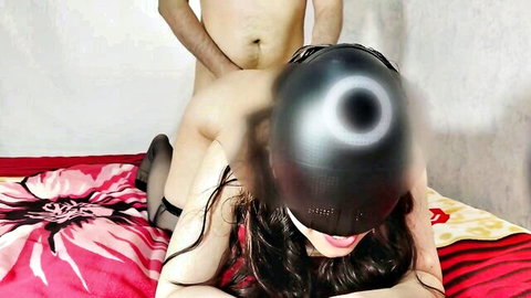 Masked woman's exposed pussy and ass grabbed by man's hand as his hard cock presses against her doggy style on bed
