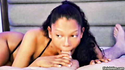 Curly-haired black beauty gives POV blowjob sucking white cock with handjob on bed