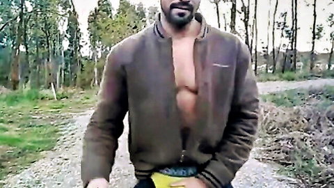 Muscular Portuguese bear stripping outdoors, bulging in yellow underwear