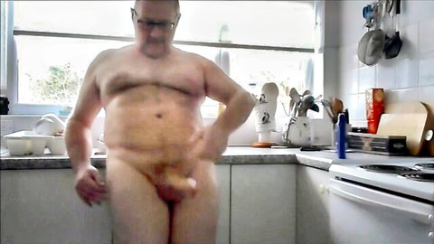 Mature bald daddy posing nude in kitchen, erect cock visible