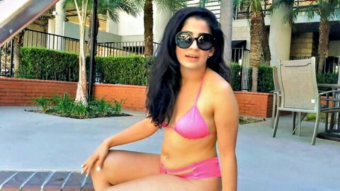 Nadia Ali in sexy pink bikini lounging poolside