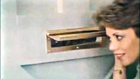 Vintage 80s brunette in green dress peeking into mailbox seductively, Ten Little Maidens 1985