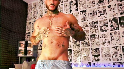 Jackson Cottonwood muscular tattooed body shirtless in low gray shorts
