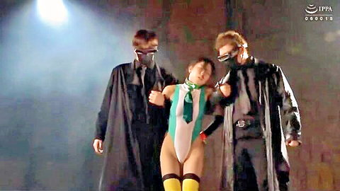 Two masked men in black cloaks grab busty Asian babe in skimpy green slingshot bikini