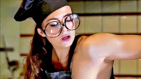 Sexy brunette chef in apron and big glasses teasing pose