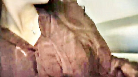 Blurry close-up of brunette woman in brown jacket and necklace