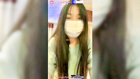 Masked Asian girl in green top solo amateur play