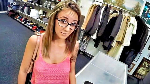 Blonde woman with glasses in pink tank top, surprised expression in store setting