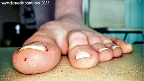 Close-up of pale bare female foot in giantess fetish video