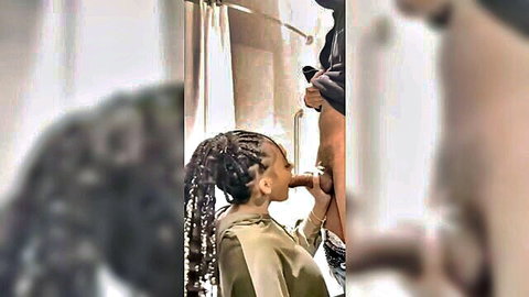 Curvy ebony woman with braids giving blowjob in shower