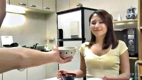 Smiling Japanese beauty in yellow v-neck top receiving bowl from man