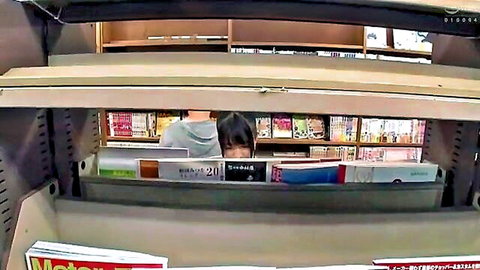 Cute Asian girl peeking through adult magazine shelf in store
