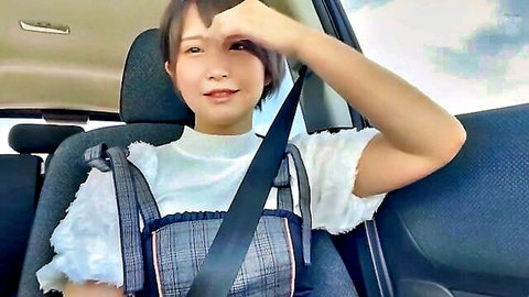 Cute Japanese woman in car, short hair, white top with black suspenders, smiling pose, JAV thumbnail