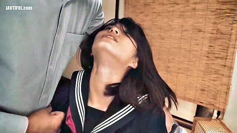 Japanese schoolgirl in sailor uniform with hand on throat, ecstatic expression