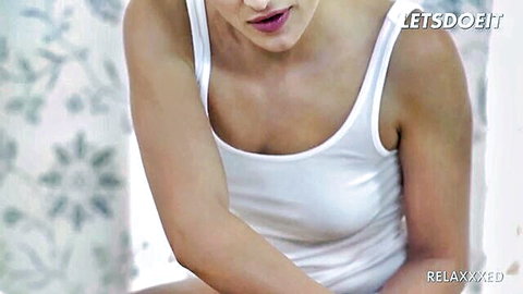 Cherry Kiss in tight white tank top, relaxing pose in sensual massage scene